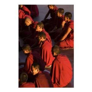monks in red robes listening teachings in Dalai Lama temple Dharamsala 