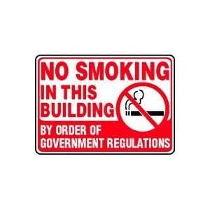 NO SMOKING IN THIS BUILDING BY ORDER OF GOVERNMENT REGUALTIONS (W 