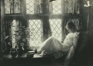 c1893photo young woman dozing on a window seat.  