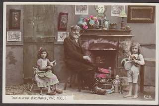 X1802 Christmas Real Photo postcard, Man and Girls by the Fireplace 