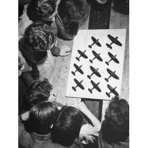  Boys Watching as Their Aircraft Models Sit Out to Dry 