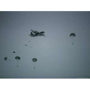  Soldiers Parachute from a Plane During a Training Exercise 