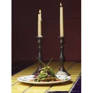 Romantic Gourmet Meal and Tall Candles Candles on Table in Restaurant 