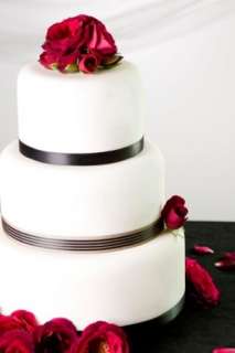 Beautiful wedding cake decorated with red roses
