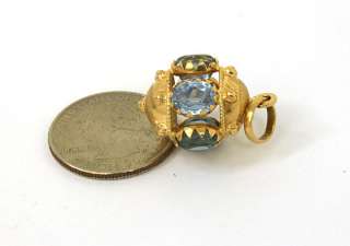 this is an exquisite vintage 18k gold and blue topaz charm pendant