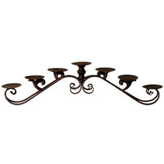   metal candle holder with brown rusty finish and lovely scroll design