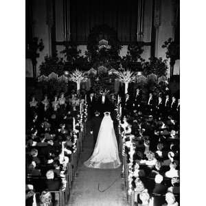 Tom Ferell and Barbara Alvin Walking Up the Aisle During their Wedding 