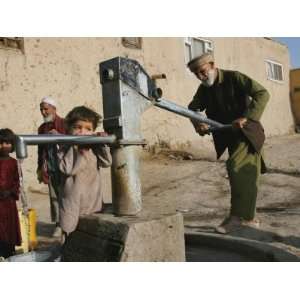 An Elderly Man Pumps Water from a Public Well in Kabul, Afghanistan 